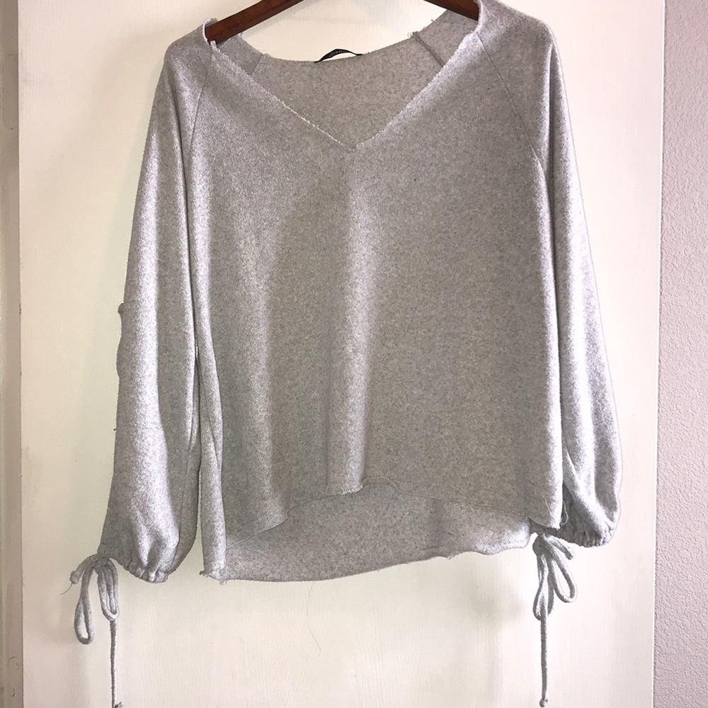Gray sweater with ties on sleeves